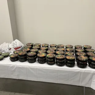a long table with many bowls of food on it