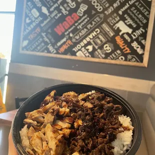 a hand holding a bowl of food