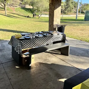 a picnic table with plates of food on it
