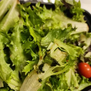 a bowl of lettuce and tomatoes