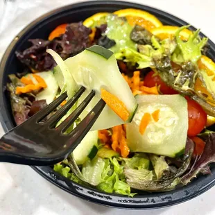 a bowl of salad with a fork