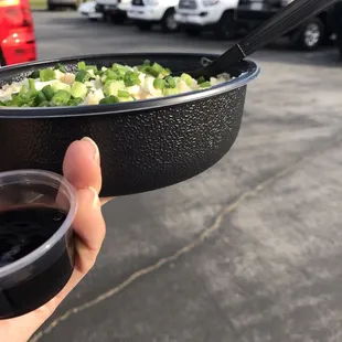 a person holding a bowl of food