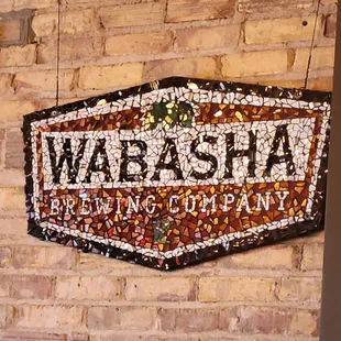 a brick wall with a sign that reads wabasha brewing company