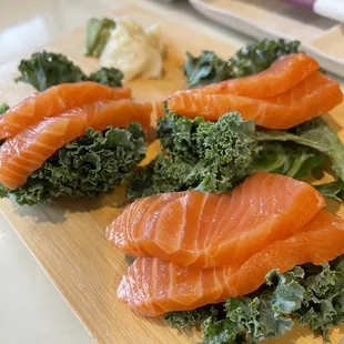 salmon and kale on a cutting board