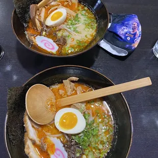 Spicy tonkotsu ramen (bottom) spicy garlic miso ramen (top)