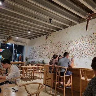 people sitting at tables in a restaurant