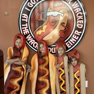 three children dressed as hot dogs