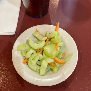 a plate of cucumbers and carrots