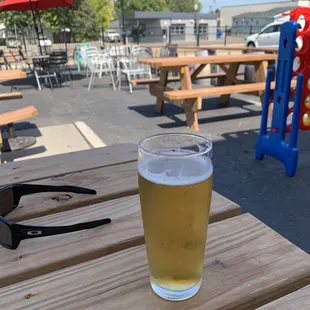 a pint of beer on a picnic table