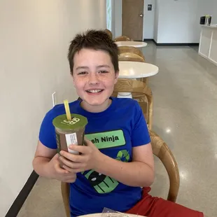 My son with his Monster Cookie Smoothie and Cookie and cream cookie.