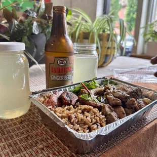 a tray of food and a bottle of beer