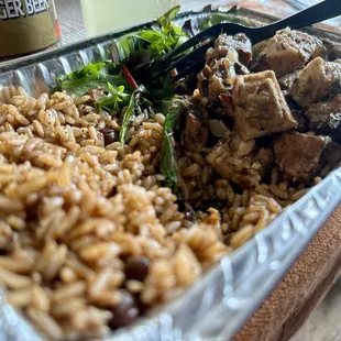 Jerked pork, salad and rice and peas