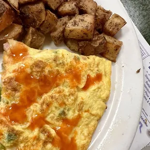Western omelette and home fries. W/hot sauce on the omelette.   I had eaten half of the plate before I took the picture.