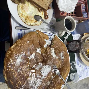 a pancake with eggs and sausage