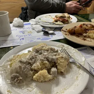 Sausage gravy and homemade biscuits. (center) 3 homemade doughnuts, (back) reminant of a breakfast sandwich!