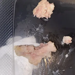a piece of meat in a plastic container