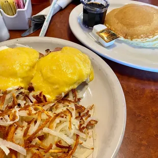 a breakfast of eggs, hash browns and pancakes