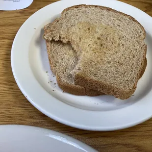 two slices of buttered, whole wheat toast