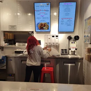 a woman standing at the counter