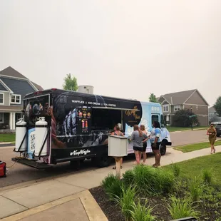 a group of people loading a food truck