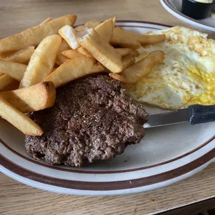 Cattle steak burger with 3 eggs over hard.  Went for French fries instead of had browns.