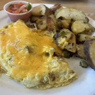 Late breakfast; bacon, omelette, fried potatoes with a pancake