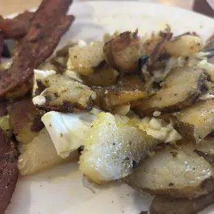 Light breakfast; fried potatoes, bacon, and over medium egg