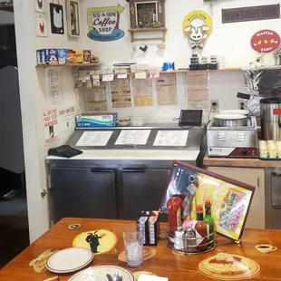 a kitchen with a table with plates and utensils on it