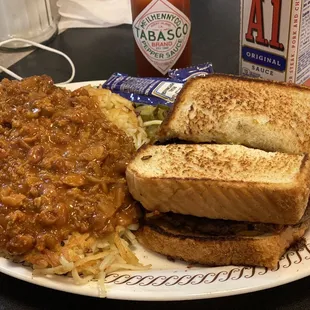 a plate of food with a sandwich and beans