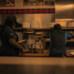 two people working in a kitchen