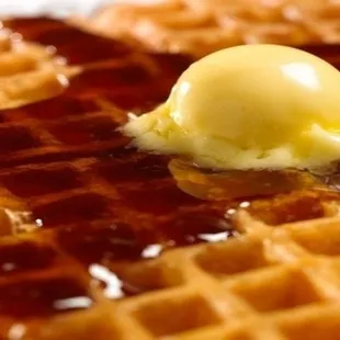 a waffle with butter and syrup
