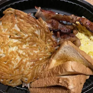 Hash browns with bacon, scrambled eggs, and toast