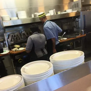Two hard working employees doing an excellent job preparing a meal