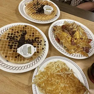 Chocolate chip waffles, plain hash browns, and covered (cheese), diced (tomatoes), chunked (ham), and smothered (onions) double hash browns