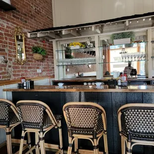 a bar with wicker chairs