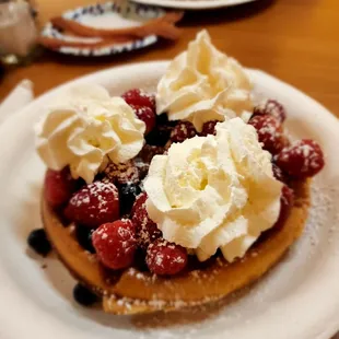 Waffle with fresh strawberries, blueberries &amp; raspberries.