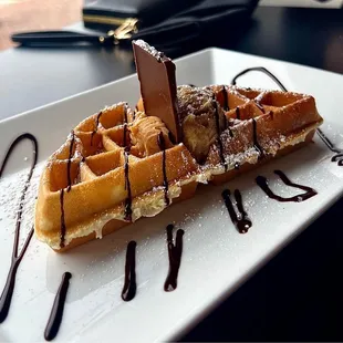 a waffle with chocolate syrup