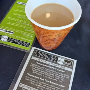a cup of coffee and a menu