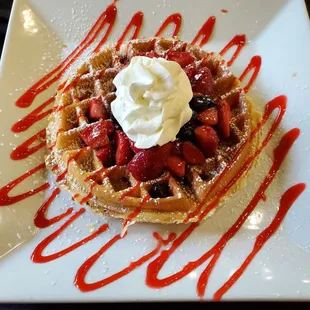 waffles topped with whipped cream and strawberries