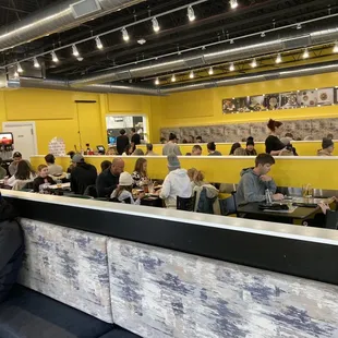people sitting at tables in a restaurant