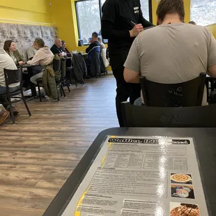 two men sitting at a table in a restaurant