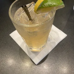 a closeup of a drink with a lime wedge