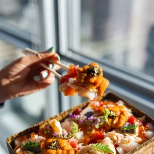 a person holding a piece of food
