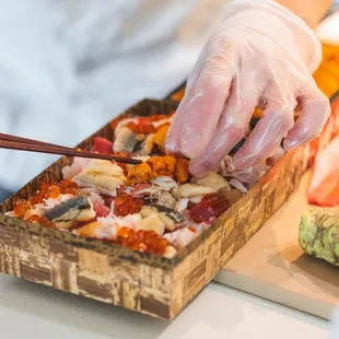 a person cutting a pizza
