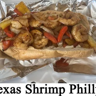 a hot dog with shrimp and peppers