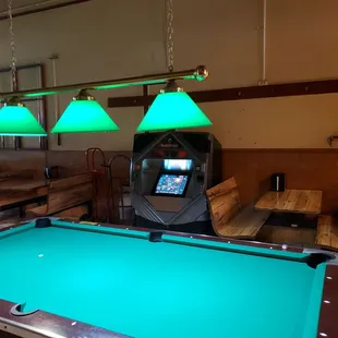 a pool table and arcade machine