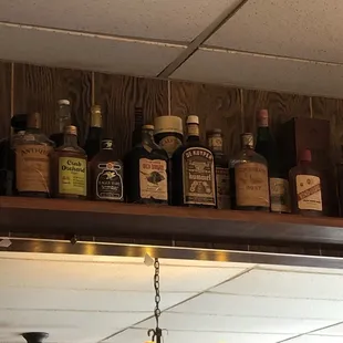 a shelf of liquor bottles