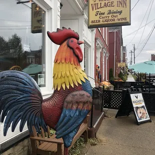 a rooster on a bench