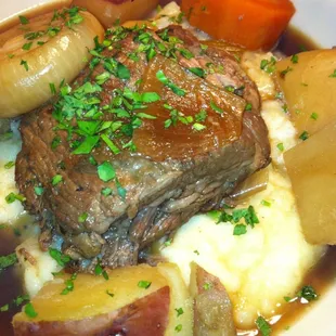 Short Rib Pot Roast on a bed of Mashed Potatoes with Root Vegetables. #wagongrill
