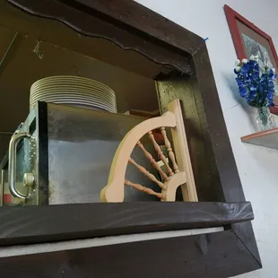 a kitchen with a wooden shelf